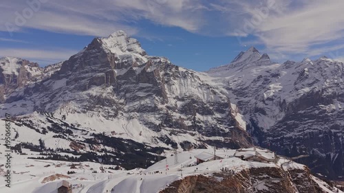 Swiss Alps in winter: drone shot of Grindelwald First station and beautiful mountain landscape.