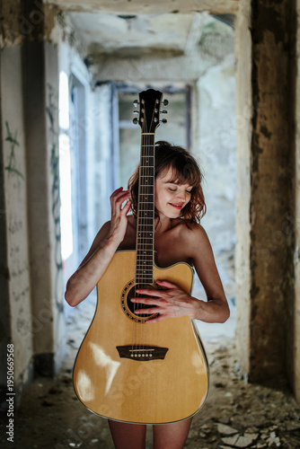 Smiling Female Musician with Acoustic Guitar