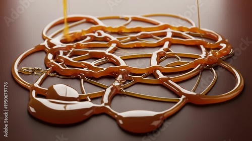 A close-up image of a brown liquid substance pouring and pooling into a complex pattern on a dark surface