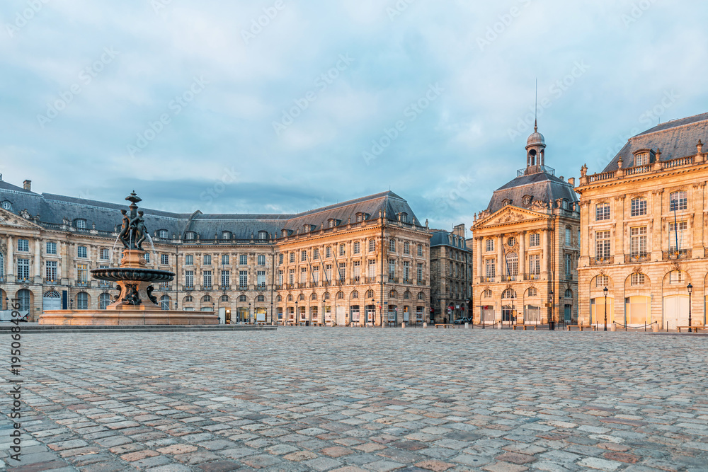 Fototapeta premium Place de la Bourse and Three Graces fountain historic square with classical architecture in Bordeaux city center, Gironde, Nouvelle-Aquitaine, France. French city square. Travel and touristic landmark