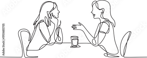 Two women talking at a table with a drink conversation