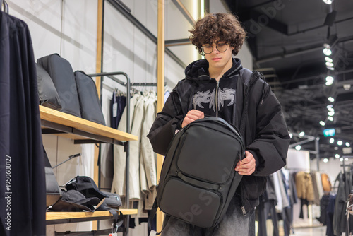 Fotografie Gen Z Teen Selecting Modern Black Backpack at Store - Urban Youth Lifestyle and