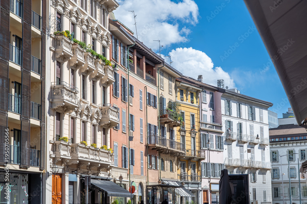 Fototapeta premium Milan, italy, april 1, 2024. Milan brera district street with colorful historic facades, balconies and shutters under a bright blue summer sky, picturesque cityscape