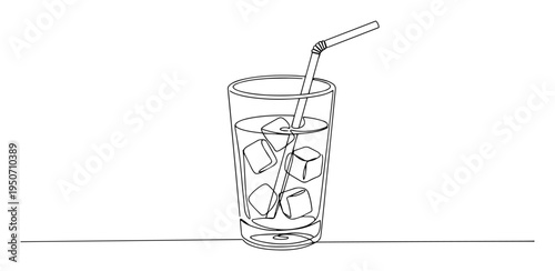 glass of drink with ice cubes and straw