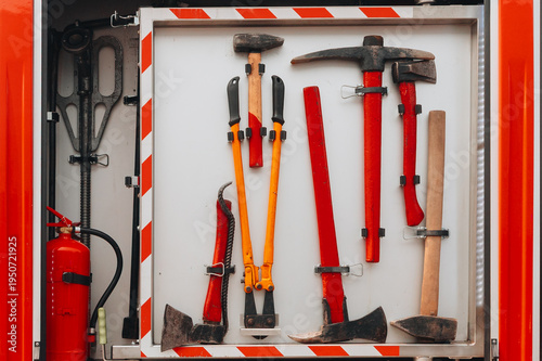 Fire truck equipment compartment with rescue tools and extinguisher