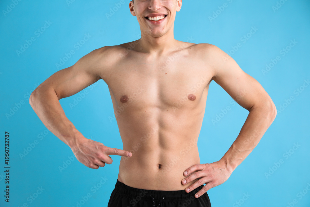 Obraz premium Athletic man on light blue background, closeup