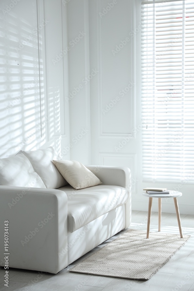 Fototapeta premium Sofa, table and window with closed blinds indoors