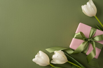 Happy Mother's Day composition with white tulip blooms and a pink wrapped present tied with a green satin ribbon on an olive background conveying elegance and gratitude