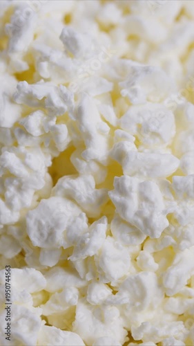 Close photograph of moist dairy curds with vibrant yellow highlights, Highresolution image capturing essence of fresh cottage cheese with yellow whey accents and creamy surface