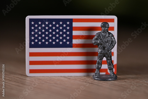 A tin soldier on the background of the flag of the United States.