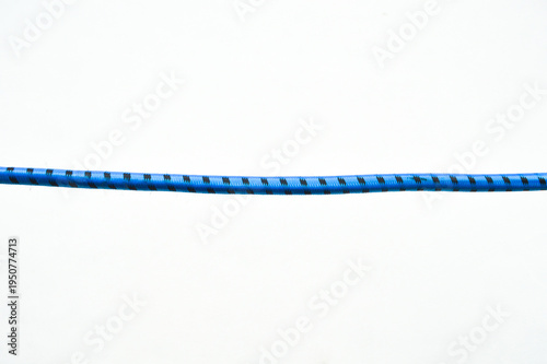 Horizontal shot of a blue and black patterned elastic cord isolated on a white background. Simple minimalist composition, industrial string, and textile detail.