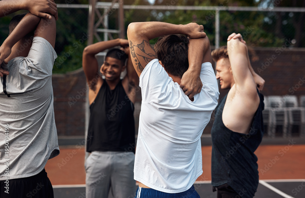 Obraz premium Arms, basketball and stretching with people outdoor together for start of competition or game. Getting ready, preparation and warm up with group of friends on court for exercise, fitness or sports