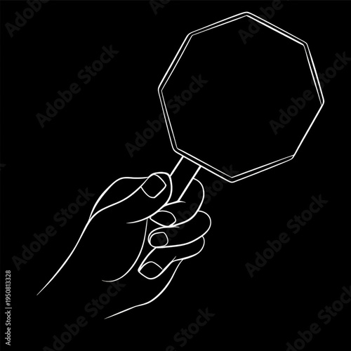 Hand Holding Octagonal Hand Mirror Closeup isolated on black background.