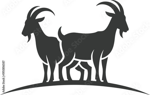 Black silhouette of two goats standing on a hill
