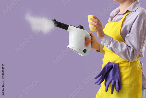 Female janitor with steam c...