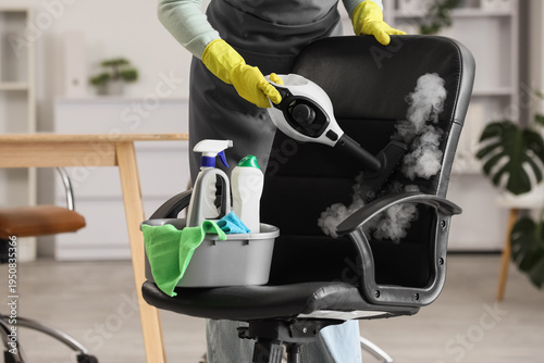Female janitor steam cleani...