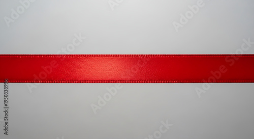 Vibrant red satin ribbon texture on white minimalist background