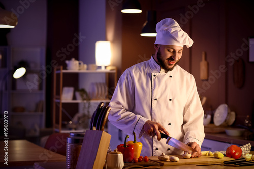 Male chef cutting mushroom ...