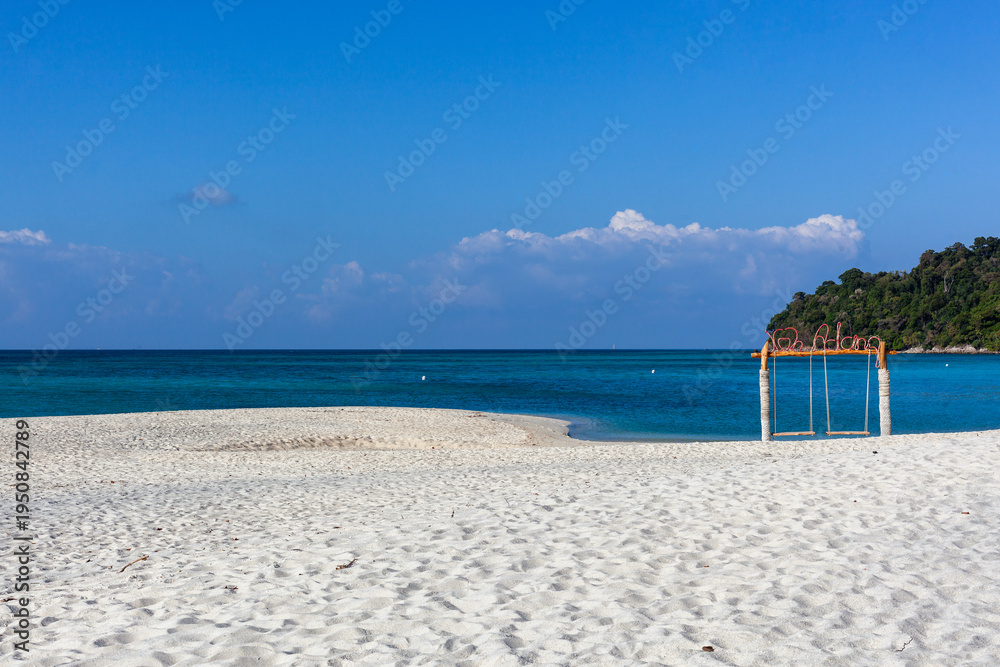 Fototapeta premium Koh Adang Beach, Thailand. White sand beach with turquoise ocean water. Swing on the shore with clear blue sky. Tropical paradise in Andaman Sea.