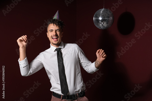 Happy young man with disco ...