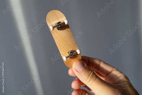 Fingerboard skateboard toy with wooden deck.