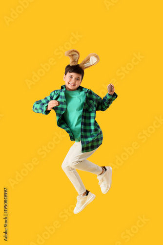 Jumping cute boy in bunny e...