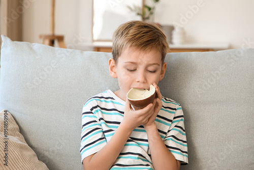 Cute little boy eating choc...