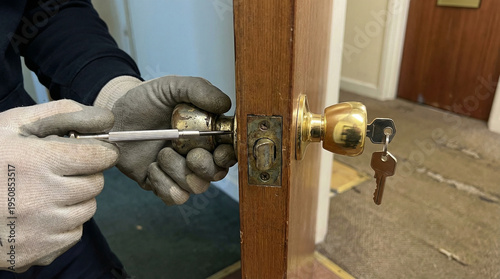 A man is working on a door with a keyhole