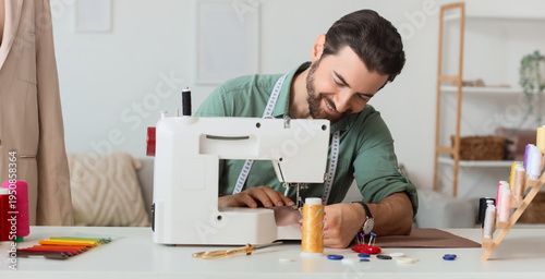 Male tailor sewing clothes ...