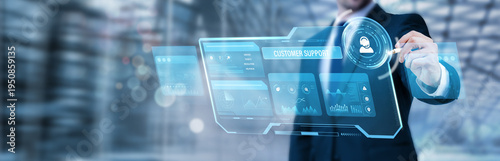 Photos Businessman pointing at a digital screen and analyzing customer support systems,