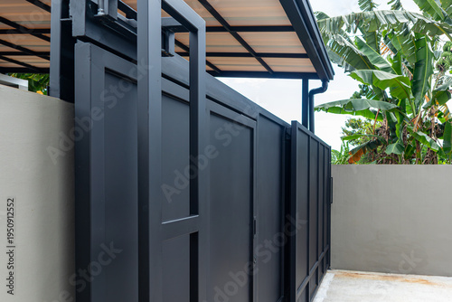Big bold black sliding iron plate fence, simple modern minimalist