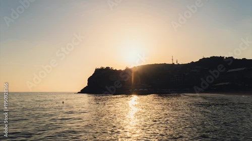 Time lapse of sun goes down Waves crashing splashing sandy beach on seashore in Antalya Turkey during sunset. Sea vacation travel tourism scene concept. Tranquility and slowing down relaxing 