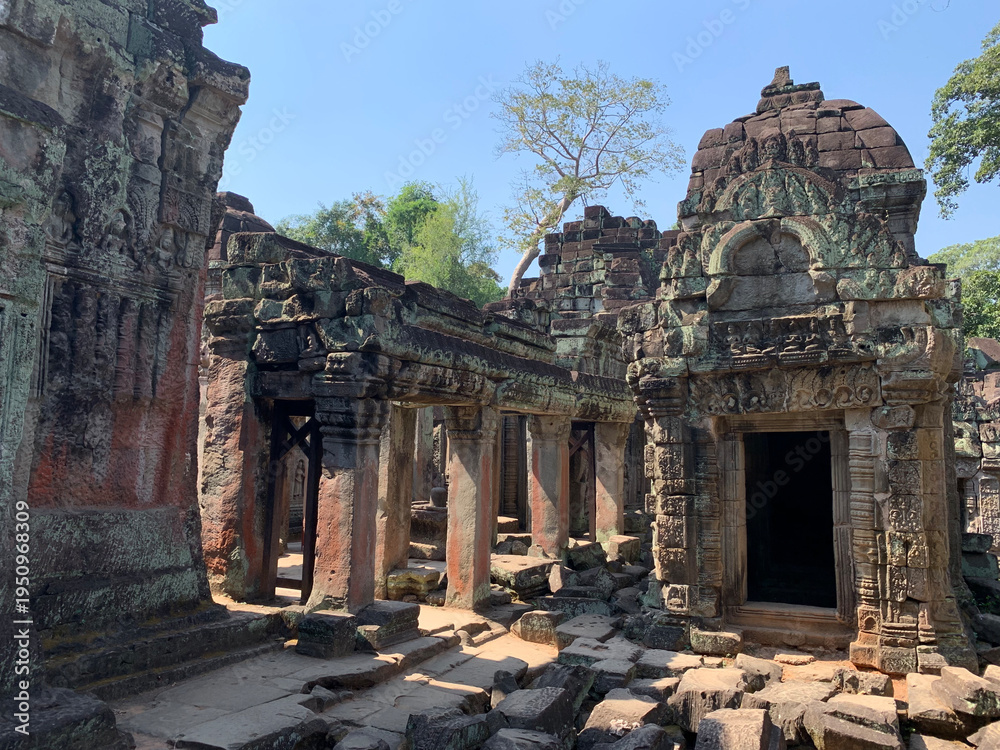 Fototapeta premium The ancient moss covered stone walls of the temples in the Angkor area of Siem Reap, Cambodia tell about the might of an ancient empire