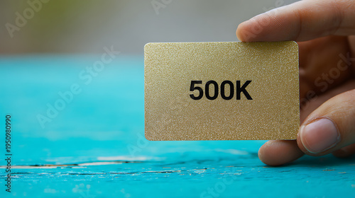 Human hand hold a shiny golden card showing 