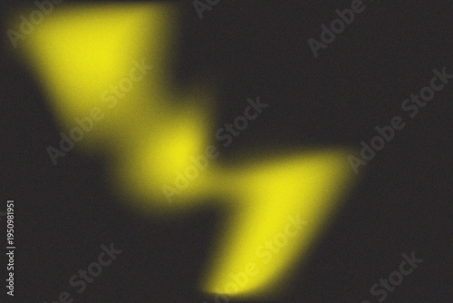 Abstract yellow blurred liquid shape on black background with grainy texture
