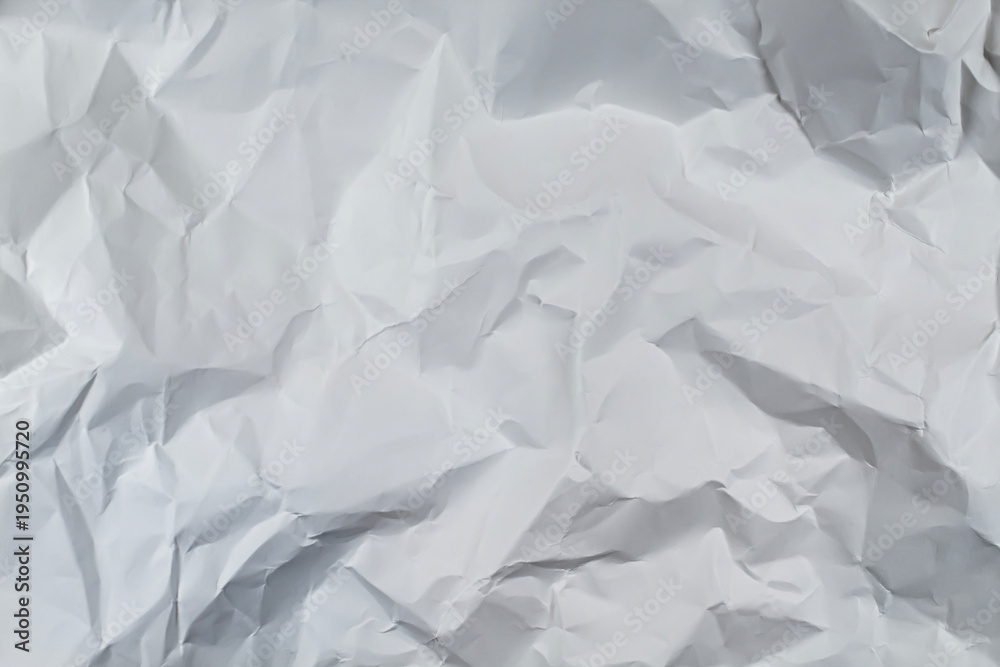 Obraz premium White crumpled paper texture background with wrinkled folds and shadows