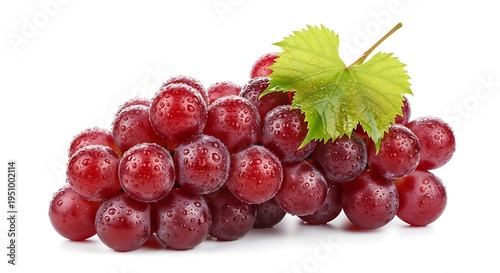 Fresh cluster of ripe red grapes glistens with moisture alongside a green leaf