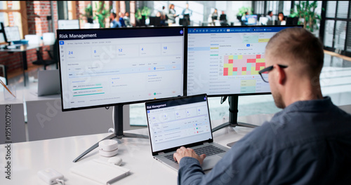 Risk Analyst Examines Data On Laptop
