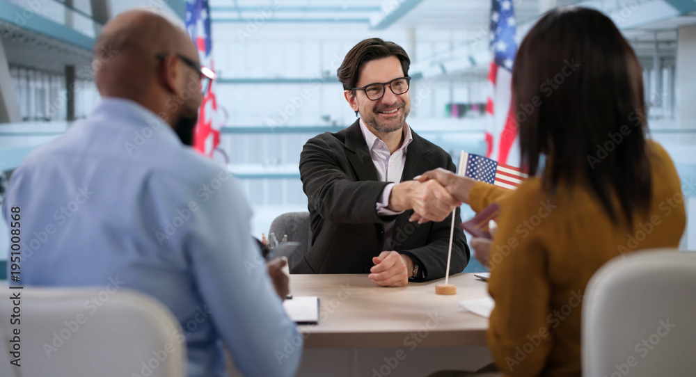 Fototapeta premium Happy Couple Smiles With Green Card As Immigration Lawyer Assists