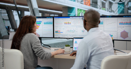 Εκτύπωση καμβά Young African Man And Woman Analyze Data On Multiple Screens