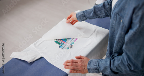 Cuadro en lienzo Woman Applying Custom Heat Transfer Design On T-Shirt With Iron