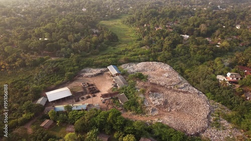 Environmental disaster on tropical coast, garbage dump in jungle by the ocean Sri Lanka aerial footage
