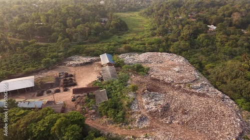 Dump site in tropical forest by ocean, Sri Lanka coastline pollution aerial view of garbage and waste problem
