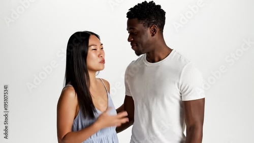 Diverse Couple Shaking Hands and Laughing Together in Studio, Close Up