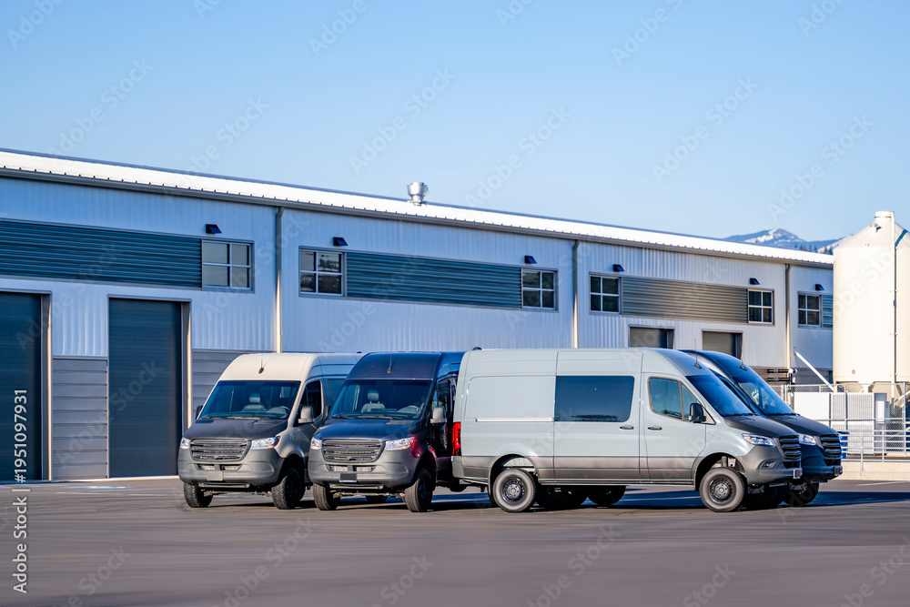 Fototapeta premium Industrial standard cargo mini vans standing on the warehouse parking lot waiting for the next loads