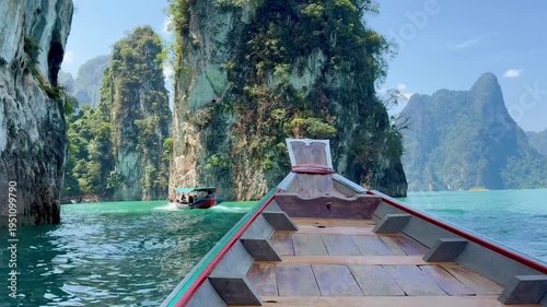 Bow of the boat moving through the beautiful limestone cliffs on the lake in Kao Sok National Park in Thailand