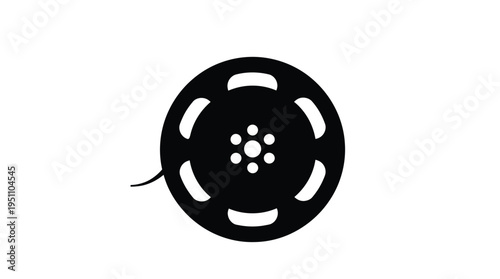 A black film reel with visible sprocket holes creating a striking silhouette