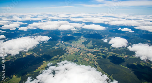 Wallpaper Mural Majestic aerial vista of planet Earth showcasing fluffy white clouds over vibrant green landscapes with blue oceans and a visible curved horizon under clear sunlight from space. Torontodigital.ca