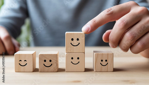 Concept of customer satisfaction and satisfaction. Wooden blocks with smiley faces.