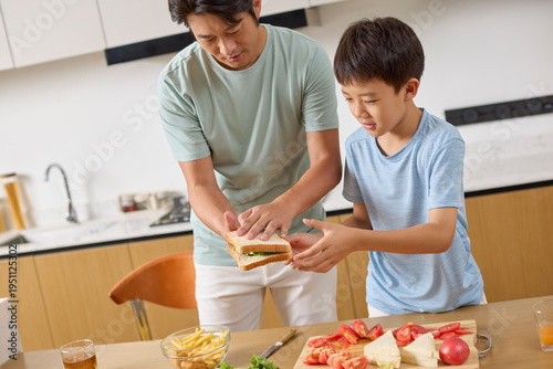 Dad walks his boy through making breakfast